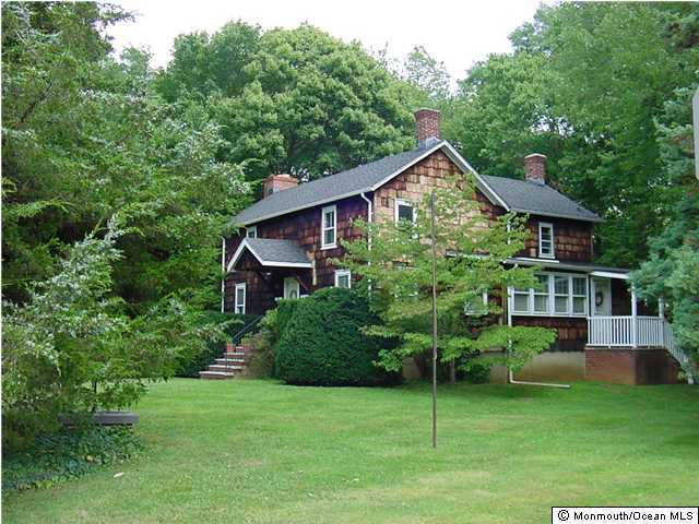 150 Stillwells Corner Road Freehold, NJ 07728 - Photo 2 of 3 a front view of a house with a garden