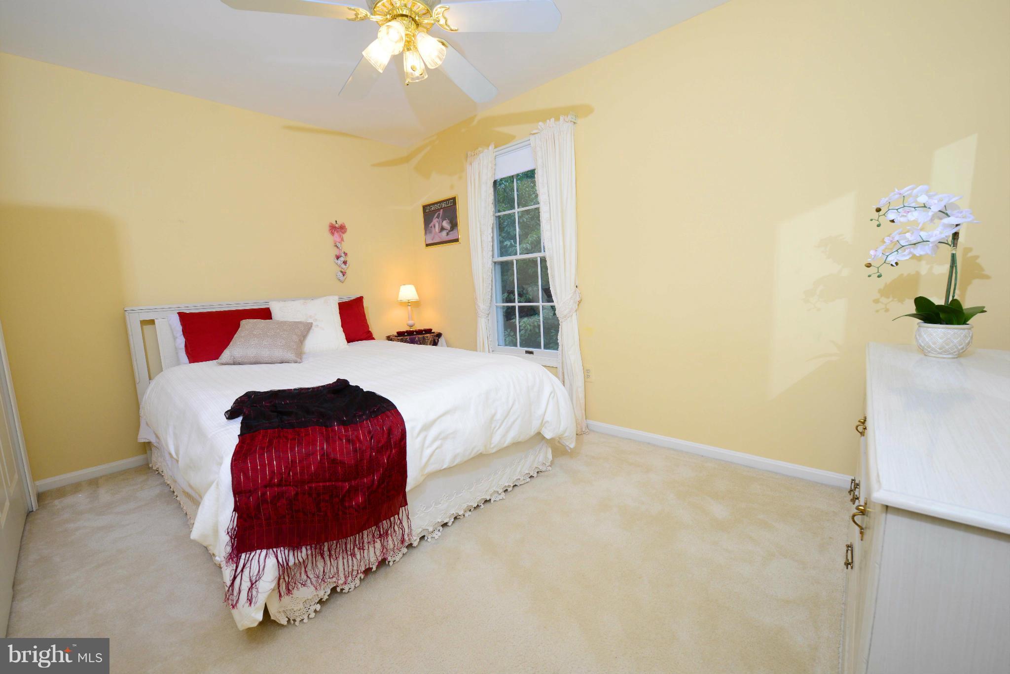 305 Riding Ridge Road Annapolis, MD 21403 - Photo 13 of 29 a bedroom with a bed and a chandelier
