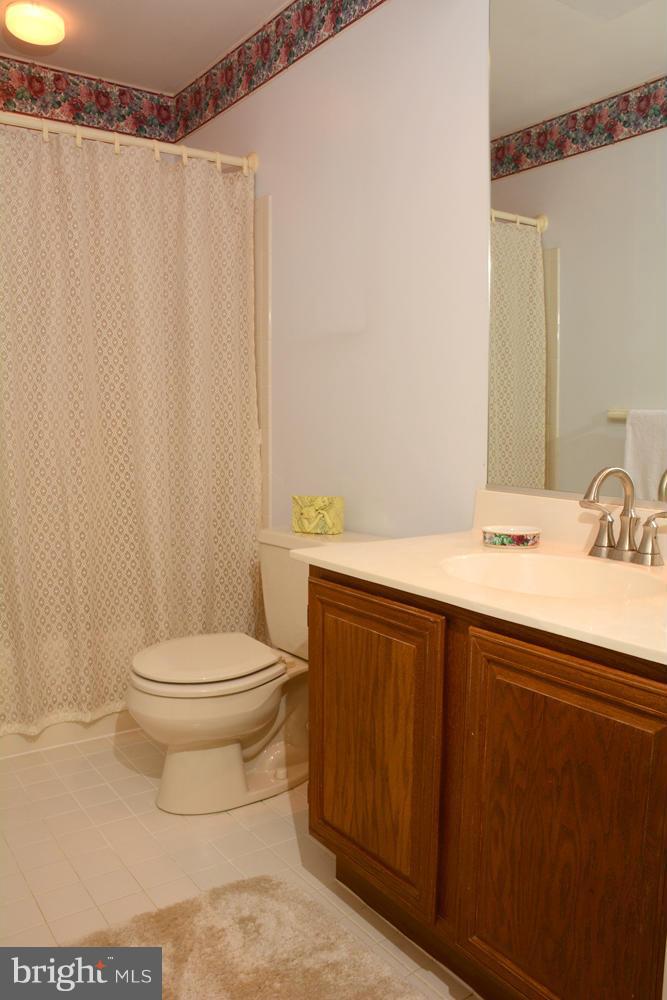 305 Riding Ridge Road Annapolis, MD 21403 - Photo 16 of 29 a bathroom with a sink a toilet and shower