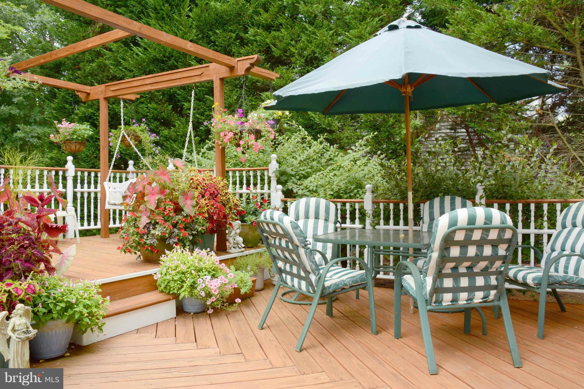 305 Riding Ridge Road Annapolis, MD 21403 - Photo 3 of 29 a view of a chair and tables under an umbrella