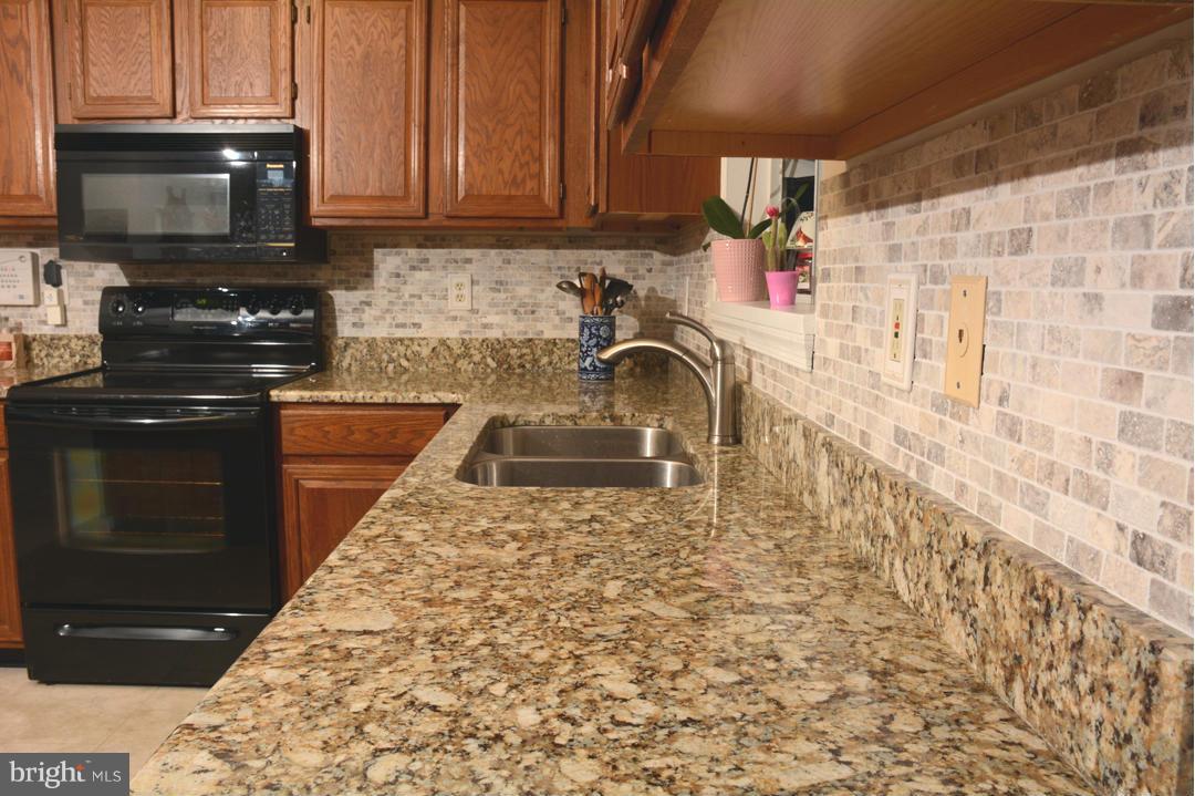 305 Riding Ridge Road Annapolis, MD 21403 - Photo 6 of 29 a kitchen with a sink and a stove top oven
