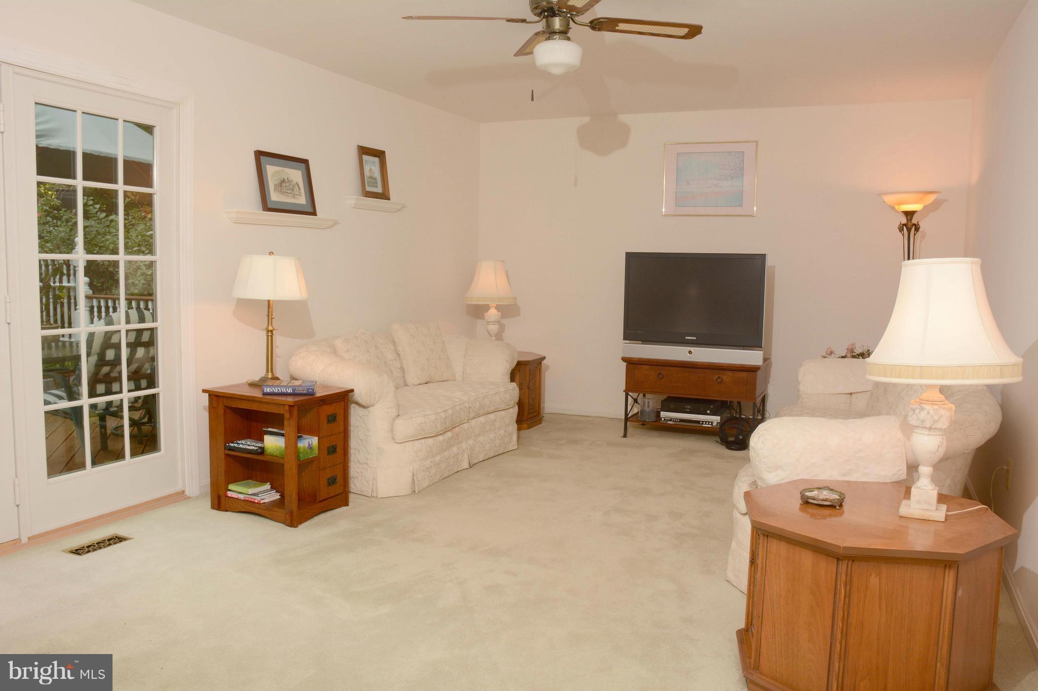 305 Riding Ridge Road Annapolis, MD 21403 - Photo 8 of 29 a living room with furniture a fireplace and a flat screen tv