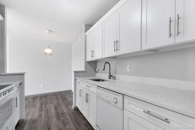 a kitchen with appliances cabinets and a sink