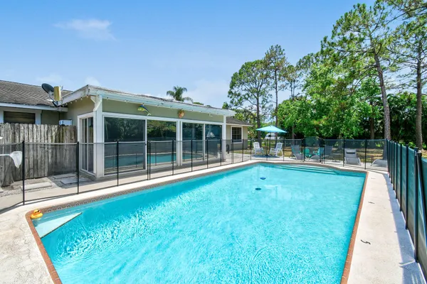 a view of a house with swimming pool and sitting area