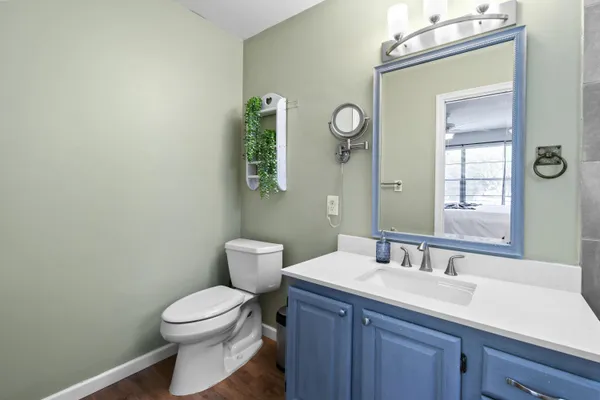 a bedroom with a bed table closet and a window