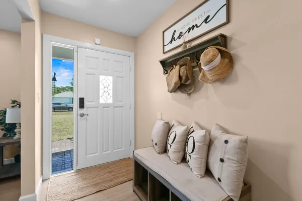 a living room with furniture and kitchen view