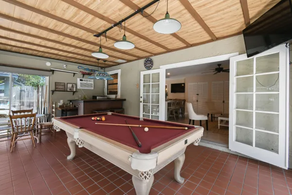 a view of a patio with a table chairs and a backyard