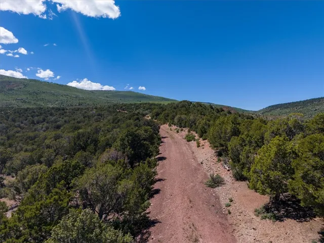 a view of mountain with sunset in background