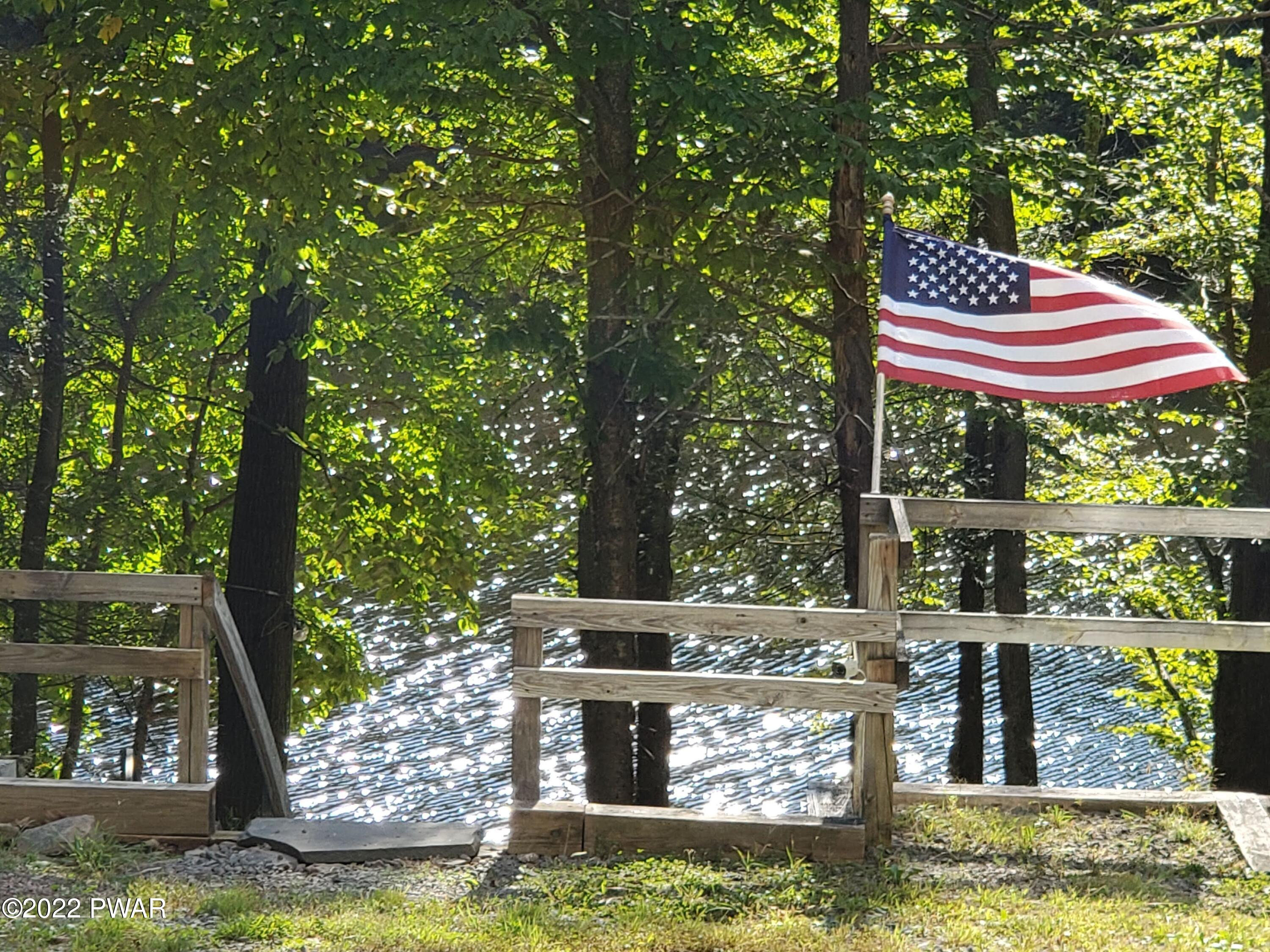 549 Finn Swamp Road Lakeville, PA 18438 - Photo 31 of 35 a small pool with lawn chairs under an umbrella