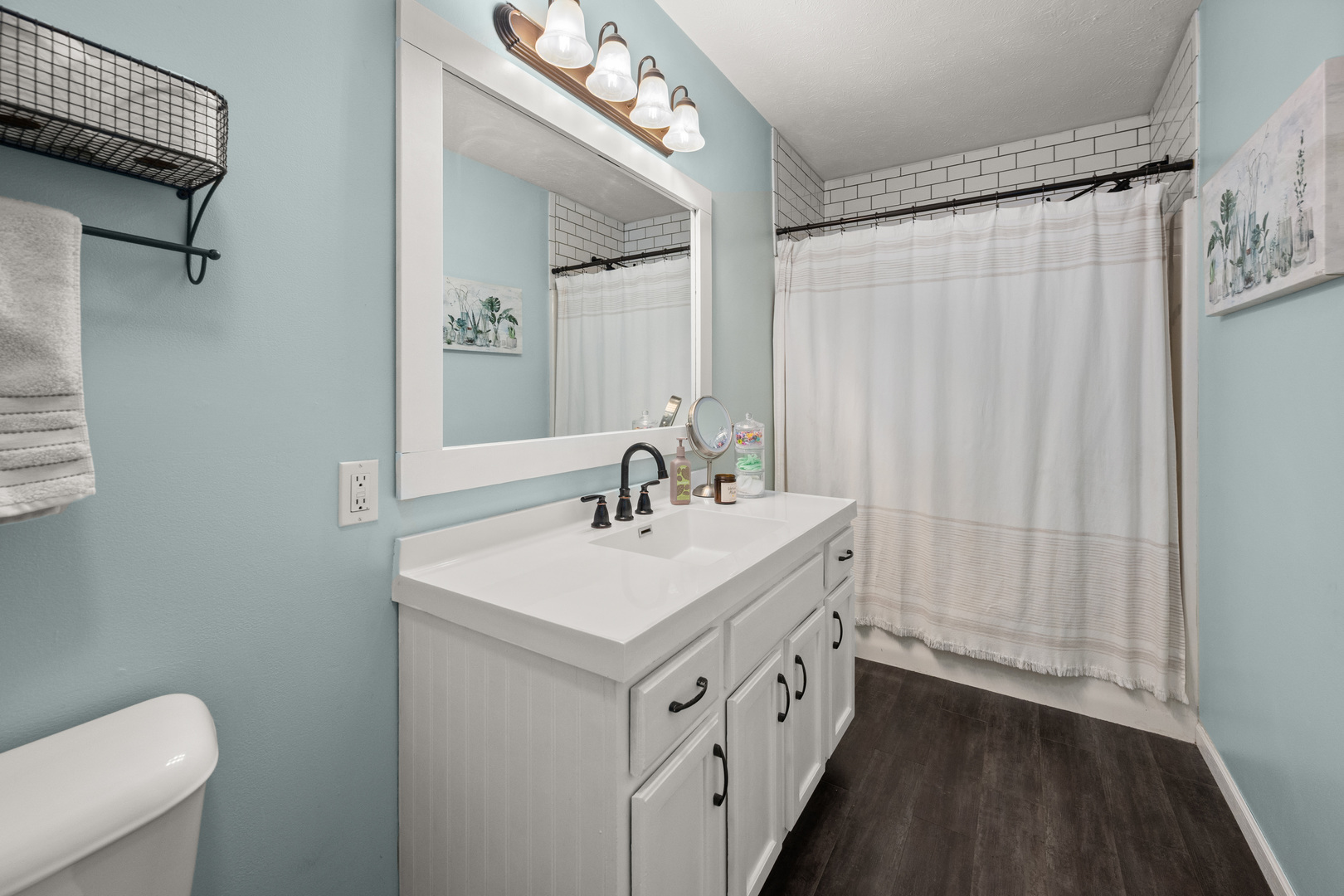 710 Hawthorne Lane Genoa, IL 60135 - Photo 12 of 24 a bathroom with a sink a toilet a mirror and shower curtain