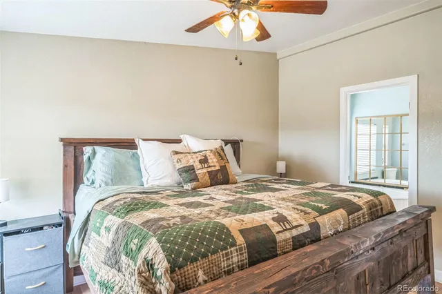 a bedroom with a bed and a chandelier