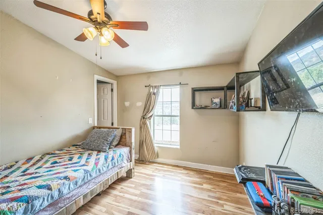 a bedroom with bed and a window