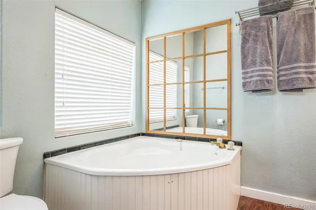a white bath tub sitting next to a window