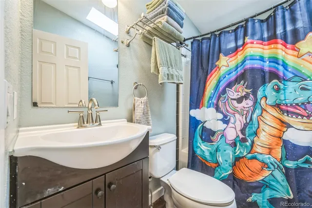 a bathroom with a sink a toilet and bathtub