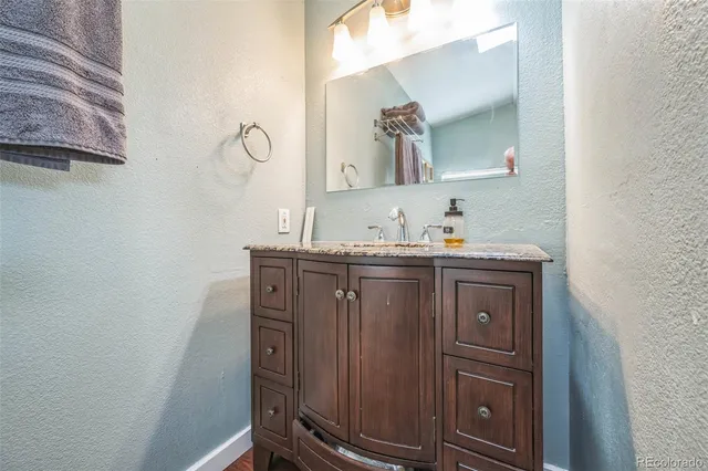a bathroom with a sink vanity and mirror