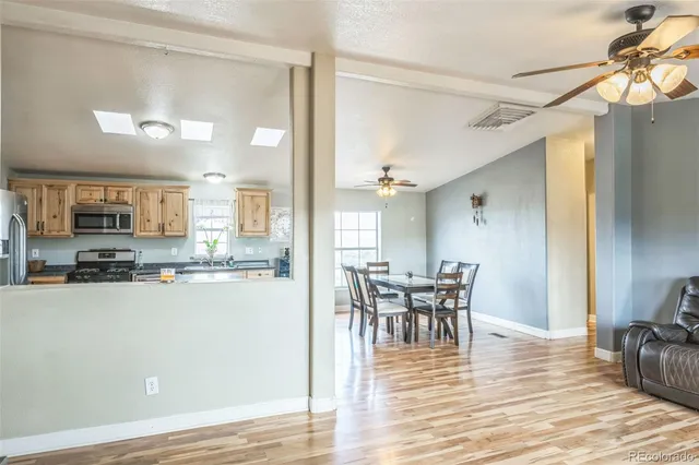 a view of a dining room with furniture and wooden floor