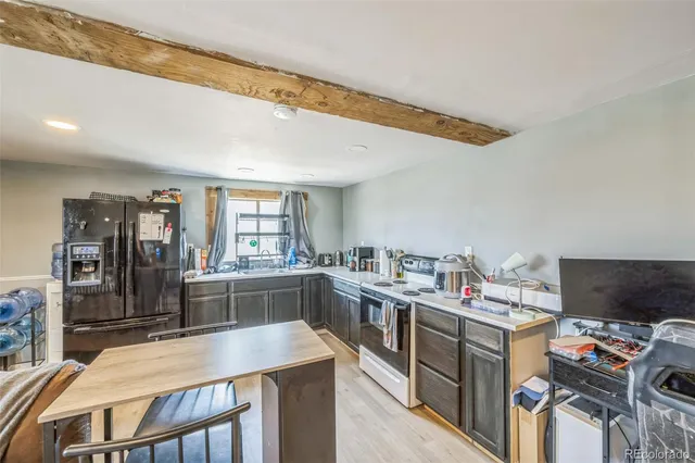 a kitchen with a stove a refrigerator and a stove