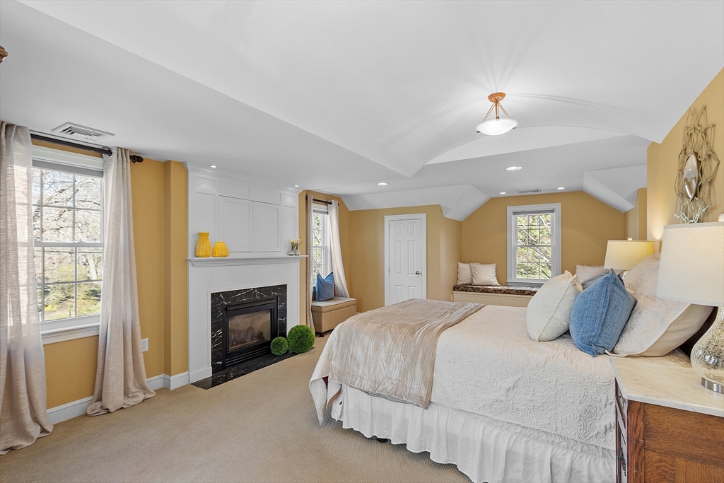 40 Bellevue Road Andover, MA 01810 - Photo 20 of 42 a spacious bedroom with a bed and a fireplace
