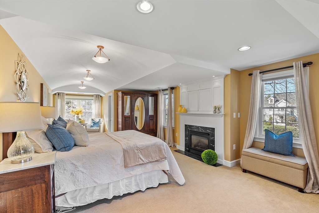 40 Bellevue Road Andover, MA 01810 - Photo 21 of 42 a spacious bedroom with a balcony a bed and a fireplace