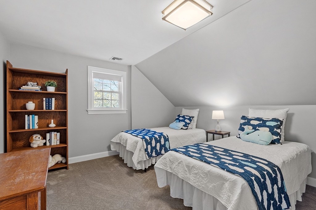 40 Bellevue Road Andover, MA 01810 - Photo 29 of 42 a bedroom with two beds and a book shelf