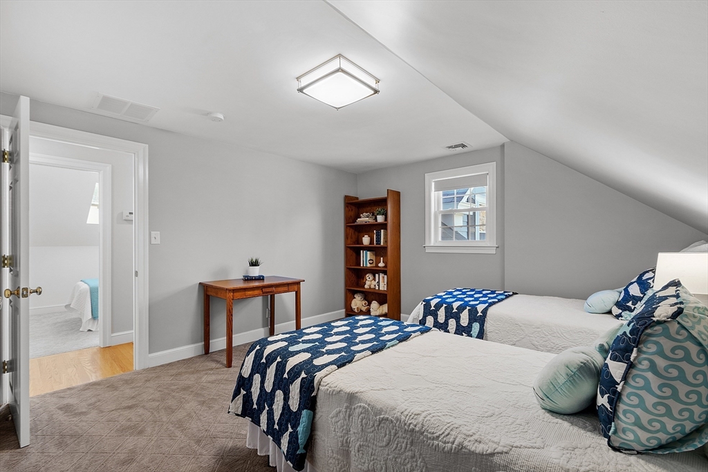 40 Bellevue Road Andover, MA 01810 - Photo 30 of 42 a bedroom with a large bed and a chandelier