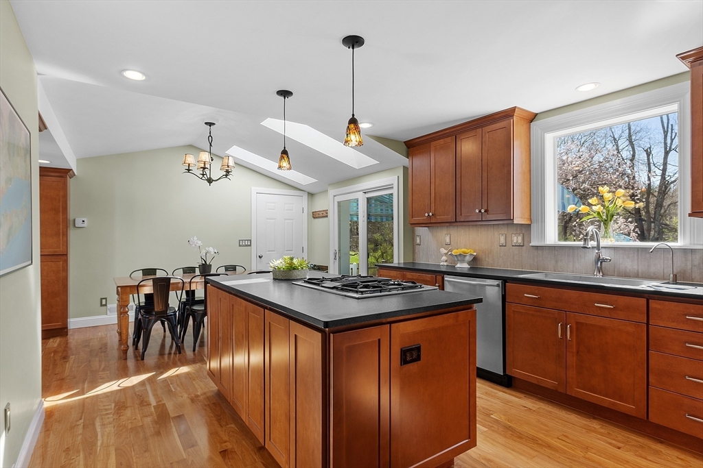 40 Bellevue Road Andover, MA 01810 - Photo 7 of 42 a kitchen with stainless steel appliances granite countertop a stove a refrigerator a sink a dining table and chairs with wooden floor
