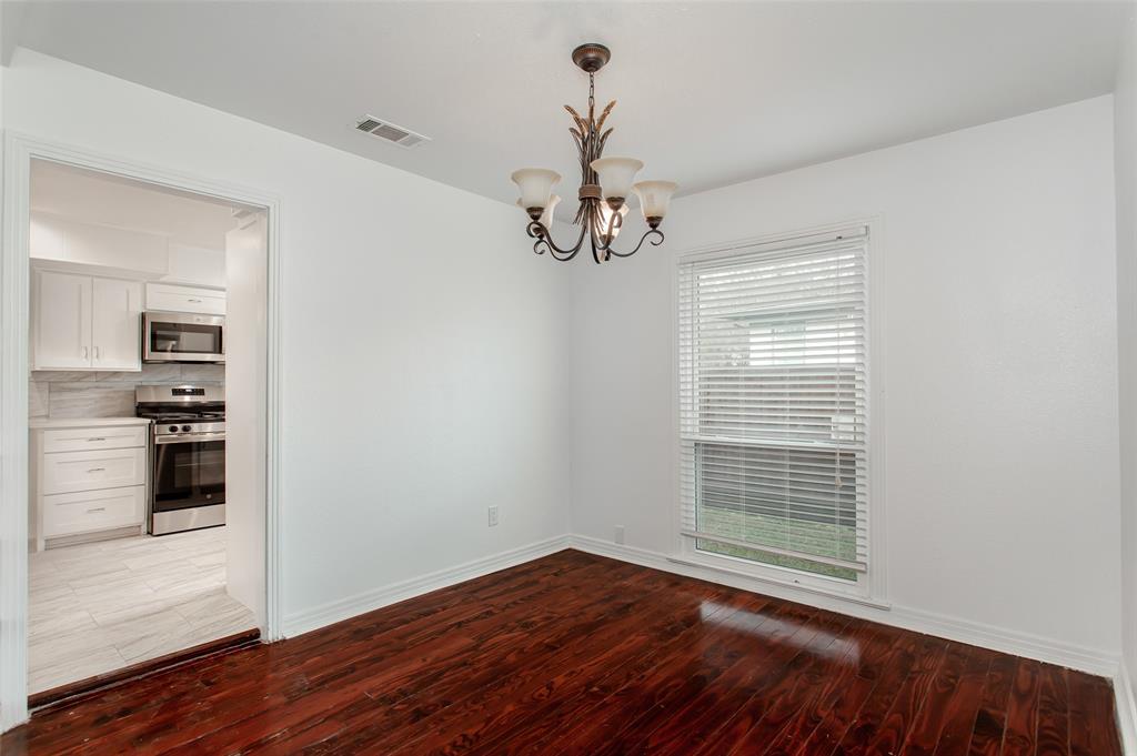 3311 Tooms Street Dallas, TX 75227 - Photo 11 of 38 a view of a room with wooden floor kitchen view and a window