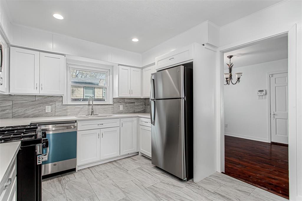 3311 Tooms Street Dallas, TX 75227 - Photo 12 of 38 a kitchen with a refrigerator sink and cabinets
