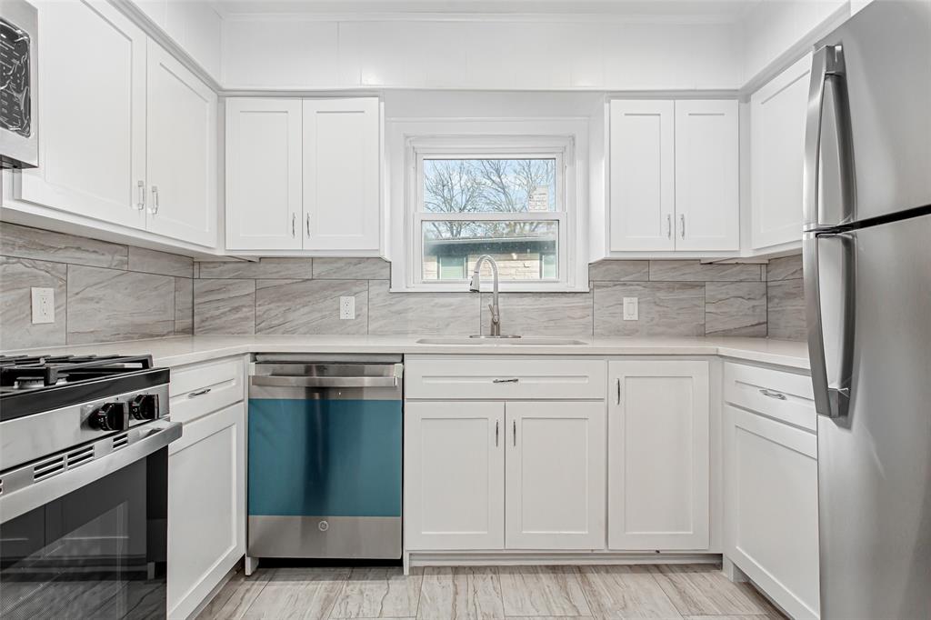 3311 Tooms Street Dallas, TX 75227 - Photo 15 of 38 a kitchen with white cabinets and white appliances