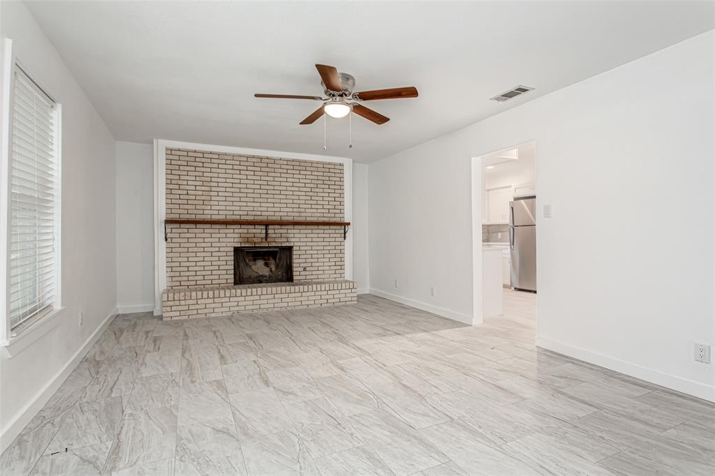 3311 Tooms Street Dallas, TX 75227 - Photo 18 of 38 an empty room with windows and fireplace