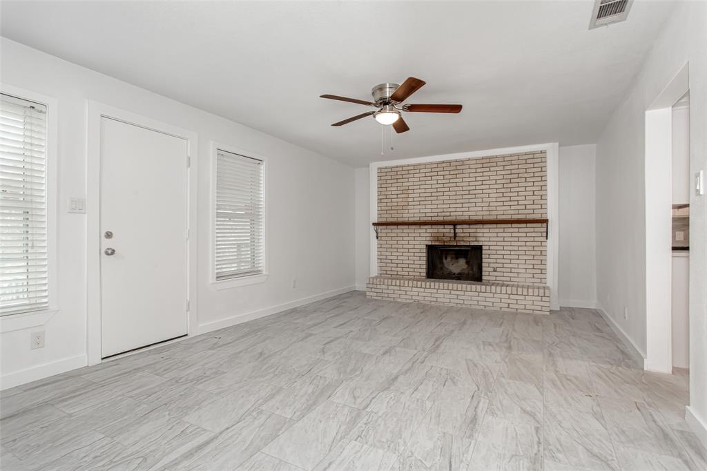 3311 Tooms Street Dallas, TX 75227 - Photo 19 of 38 a view of empty room with wooden floor and fireplace