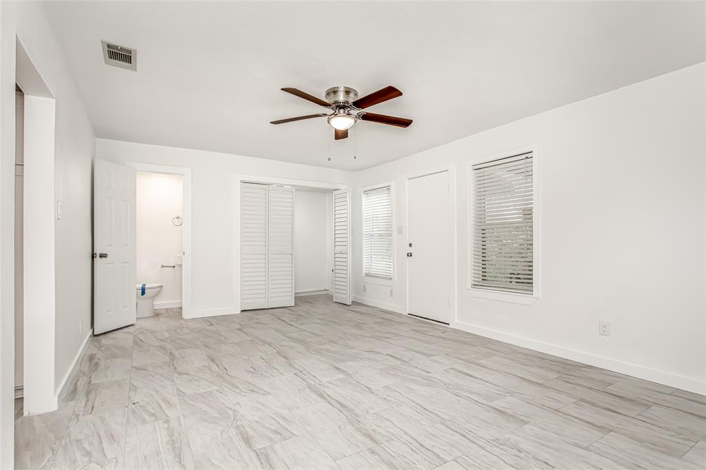 3311 Tooms Street Dallas, TX 75227 - Photo 21 of 38 a view of a livingroom with a ceiling fan & windows