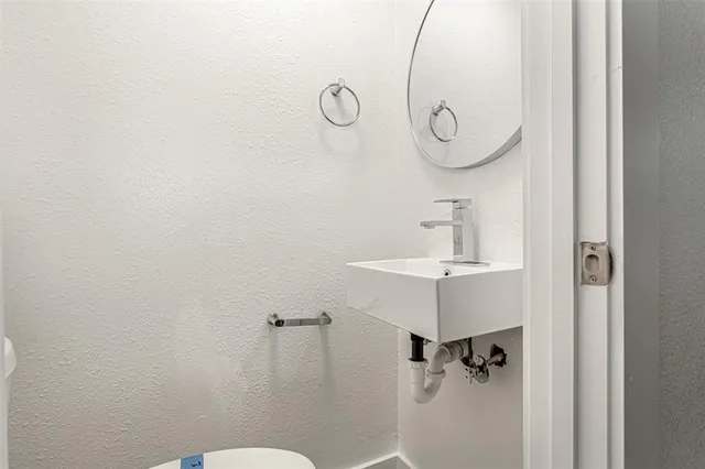 a bathroom with a sink and mirror