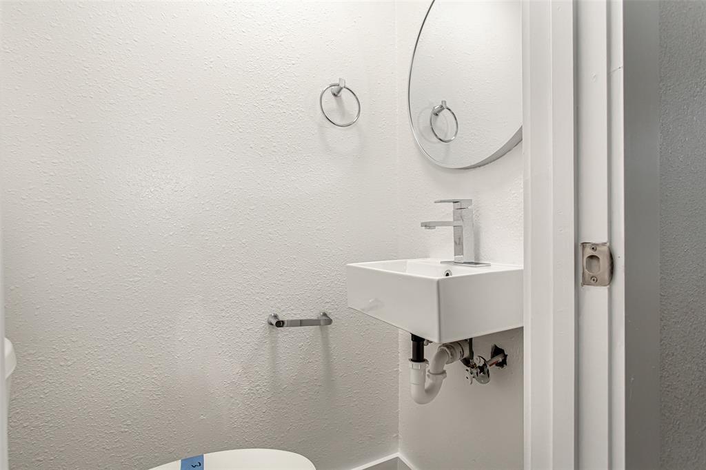 3311 Tooms Street Dallas, TX 75227 - Photo 24 of 38 a bathroom with a sink and mirror