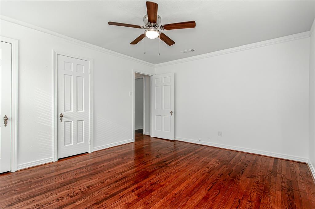 3311 Tooms Street Dallas, TX 75227 - Photo 26 of 38 an empty room with wooden floor ceiling fan and windows