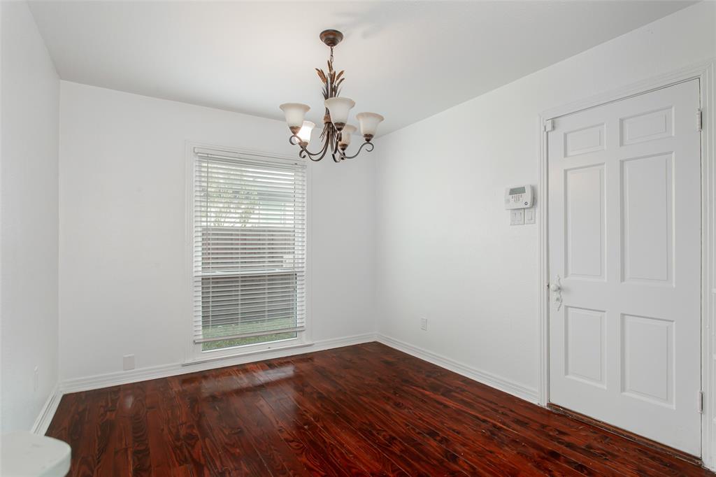 3311 Tooms Street Dallas, TX 75227 - Photo 4 of 38 a view of an empty room with wooden floor and a window