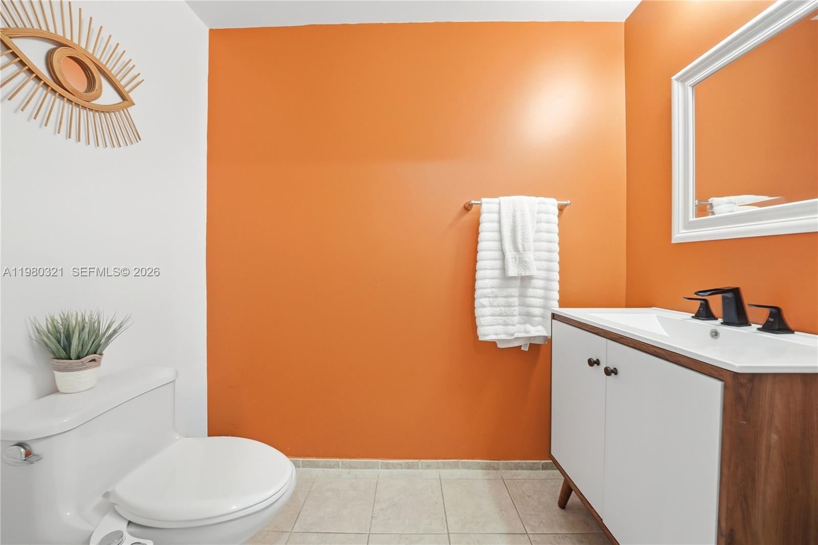 60 Southwest 13th Street, Unit 4414 Miami, FL 33130 - Photo 12 of 56 a bathroom with a sink a toilet and mirror