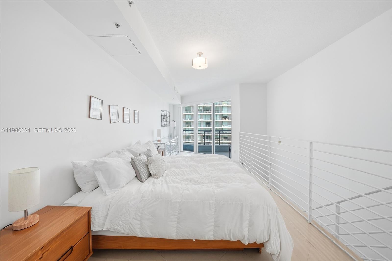 60 Southwest 13th Street, Unit 4414 Miami, FL 33130 - Photo 16 of 56 a bedroom with a bed and a window