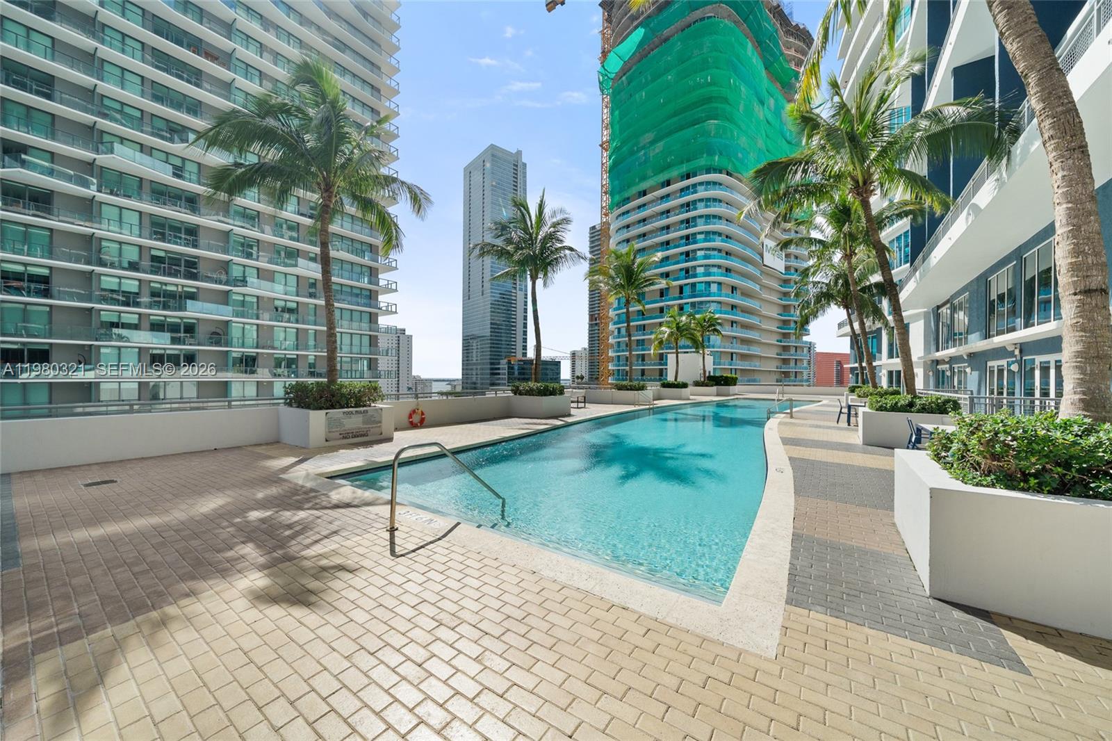 60 Southwest 13th Street, Unit 4414 Miami, FL 33130 - Photo 32 of 56 a swimming pool with outdoor seating and yard