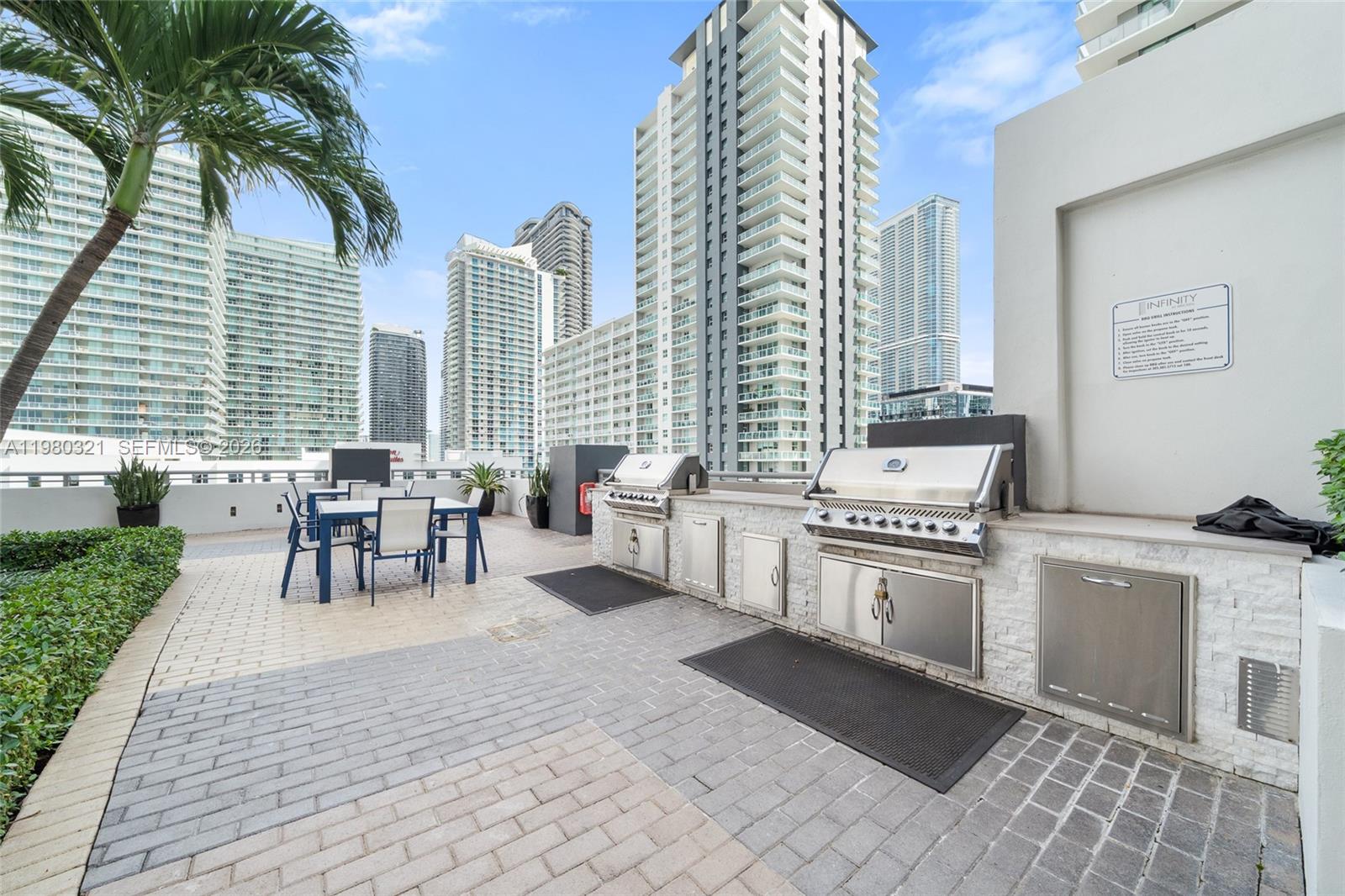 60 Southwest 13th Street, Unit 4414 Miami, FL 33130 - Photo 43 of 56 a open kitchen with stainless steel appliances granite countertop a stove a sink and a chair