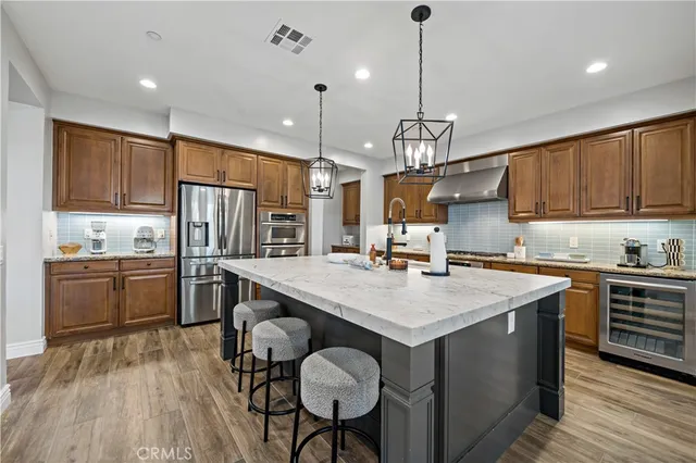 a kitchen with a center island appliances and cabinets