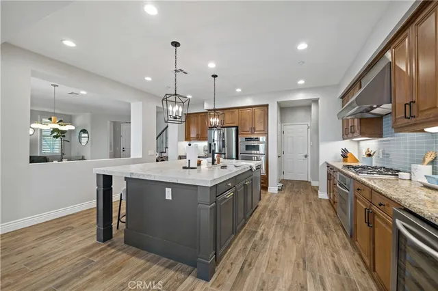 a kitchen with a sink and wooden floor