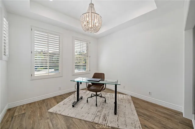 a view of a workspace with furniture and wooden floor