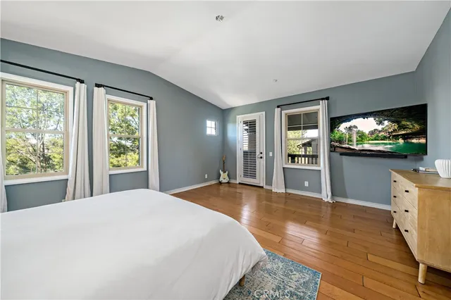 a bedroom with a white bed and dresser