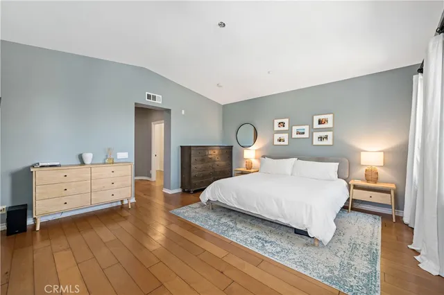 a spacious bedroom with a bed and a large window