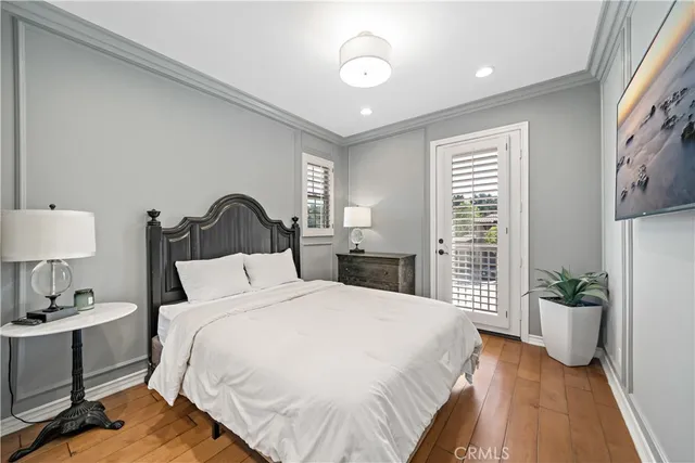 a bedroom with a bed and a painting on the wall