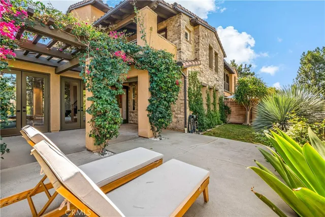 a view of an house with backyard and sitting area
