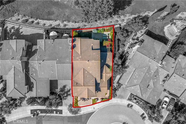 an aerial view of a house with a yard lake and ocean view