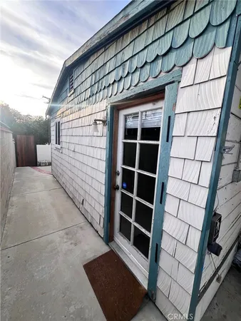a view of backyard with door and wooden floor