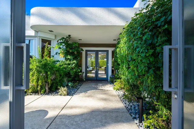 a view of a chairs and table in patio